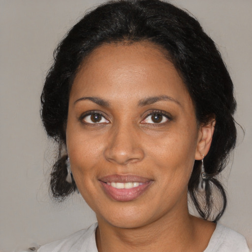 Joyful black adult female with medium  black hair and brown eyes