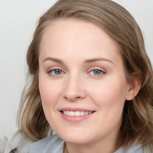 Joyful white young-adult female with medium  brown hair and blue eyes