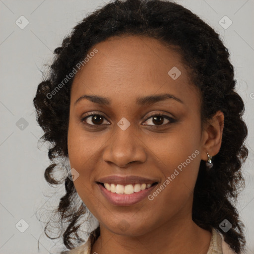 Joyful black young-adult female with long  brown hair and brown eyes