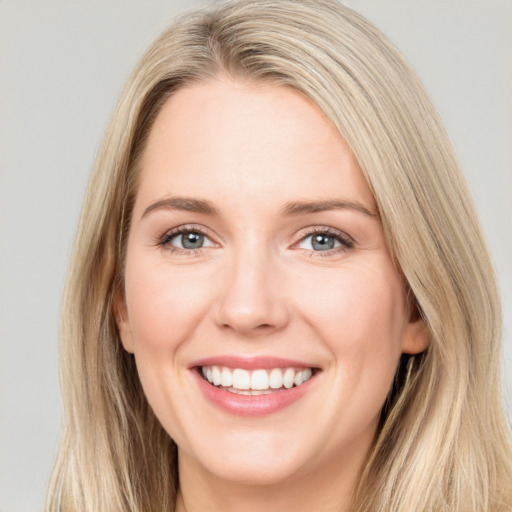 Joyful white young-adult female with long  brown hair and blue eyes