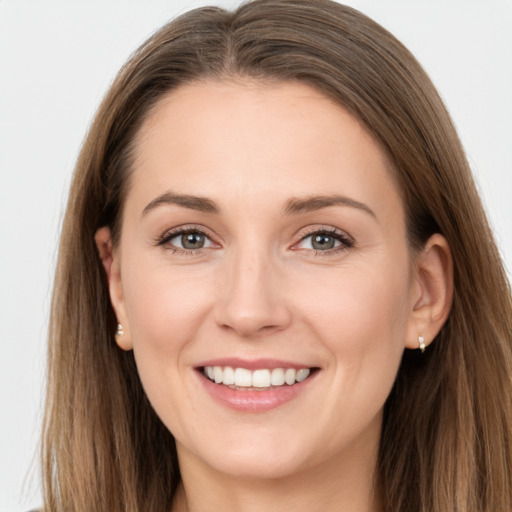 Joyful white young-adult female with long  brown hair and grey eyes