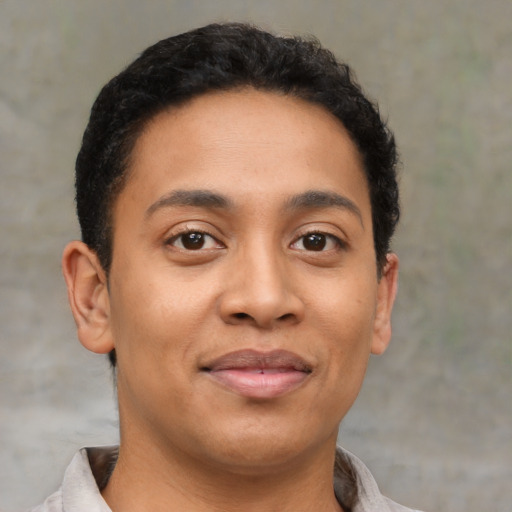 Joyful latino young-adult male with short  brown hair and brown eyes