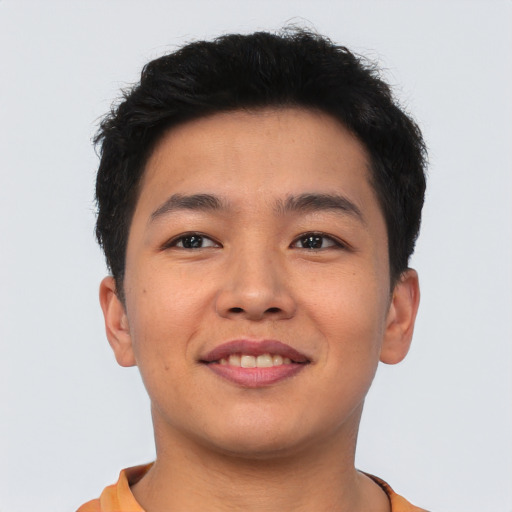 Joyful asian young-adult male with short  brown hair and brown eyes