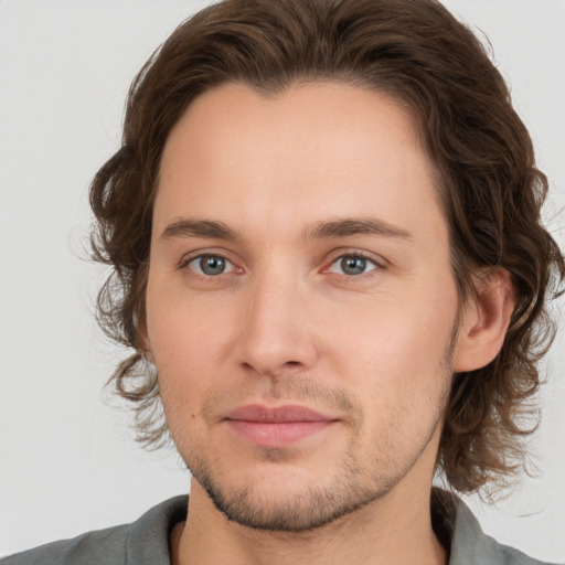 Joyful white young-adult male with medium  brown hair and brown eyes