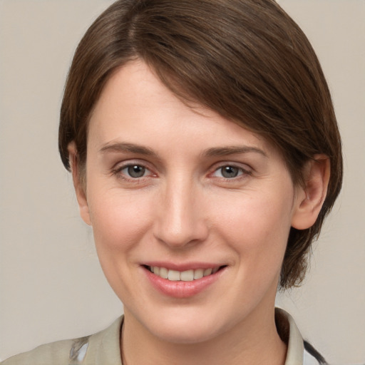 Joyful white young-adult female with medium  brown hair and grey eyes