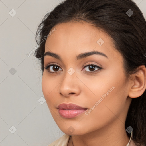 Joyful latino young-adult female with long  brown hair and brown eyes