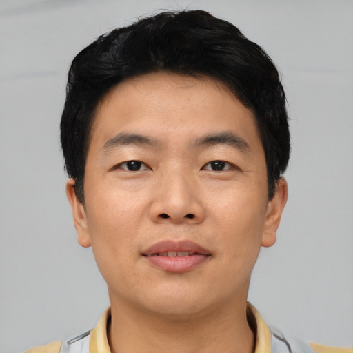 Joyful asian young-adult male with short  black hair and brown eyes