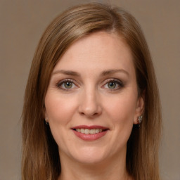 Joyful white young-adult female with long  brown hair and green eyes