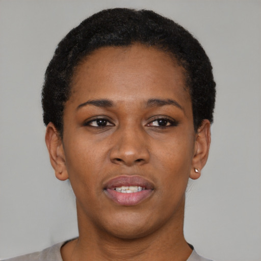 Joyful black young-adult female with short  black hair and brown eyes