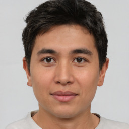 Joyful asian young-adult male with short  brown hair and brown eyes