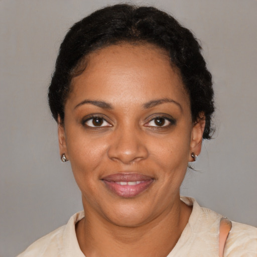 Joyful black adult female with short  black hair and brown eyes