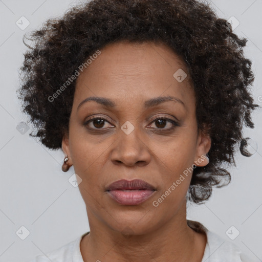 Joyful black adult female with short  brown hair and brown eyes