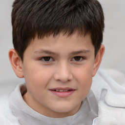 Joyful white child male with short  brown hair and brown eyes