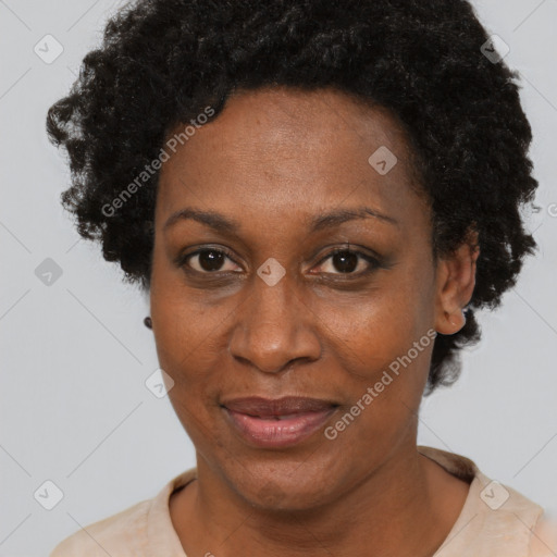 Joyful black adult female with short  black hair and brown eyes