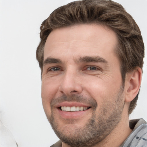 Joyful white adult male with short  brown hair and grey eyes