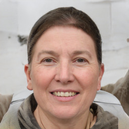 Joyful white adult female with short  brown hair and grey eyes