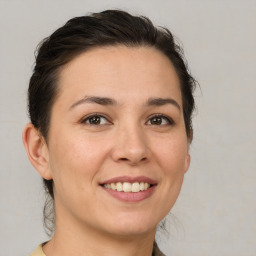 Joyful white young-adult female with medium  brown hair and brown eyes