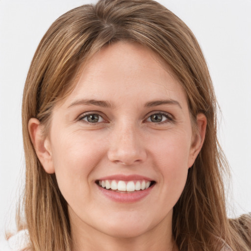 Joyful white young-adult female with long  brown hair and grey eyes