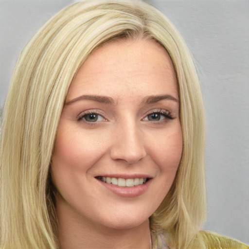 Joyful white young-adult female with long  blond hair and blue eyes