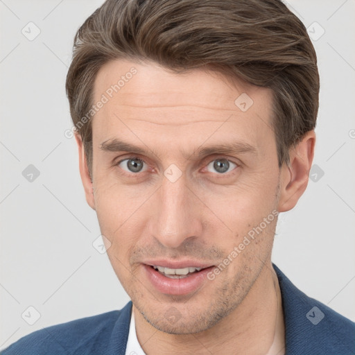 Joyful white adult male with short  brown hair and grey eyes