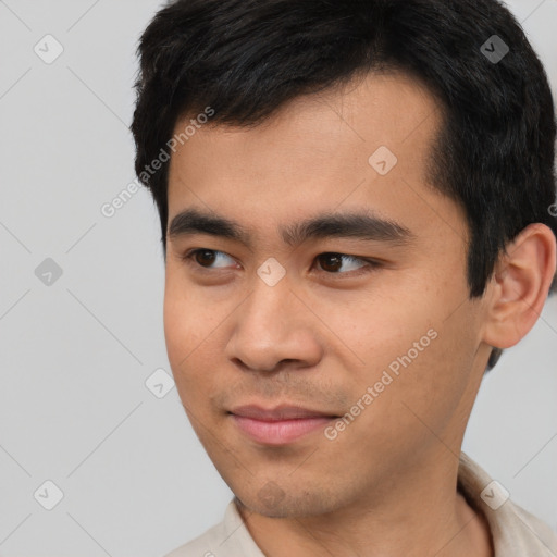 Joyful asian young-adult male with short  black hair and brown eyes