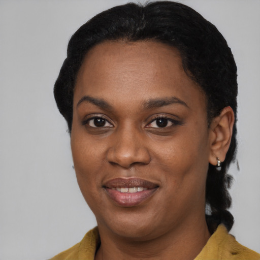 Joyful black young-adult female with short  black hair and brown eyes