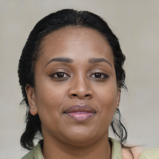 Joyful black young-adult female with medium  brown hair and brown eyes