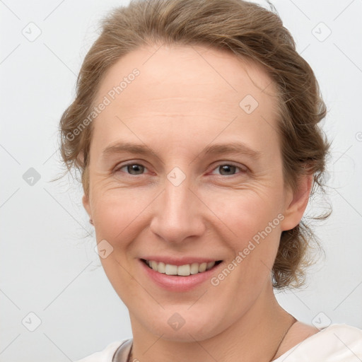 Joyful white adult female with medium  brown hair and grey eyes