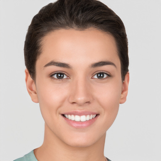 Joyful white young-adult female with short  brown hair and brown eyes