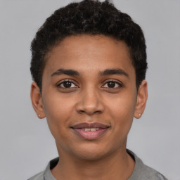 Joyful latino young-adult male with short  brown hair and brown eyes