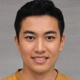 Joyful asian young-adult male with short  black hair and brown eyes