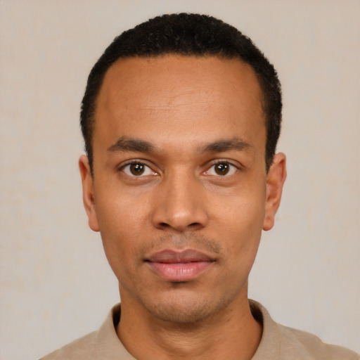 Joyful black young-adult male with short  black hair and brown eyes