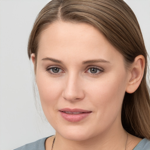 Joyful white young-adult female with long  brown hair and grey eyes