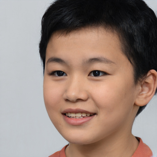 Joyful asian child male with short  brown hair and brown eyes