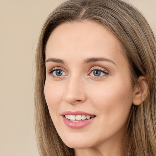 Joyful white young-adult female with long  brown hair and grey eyes