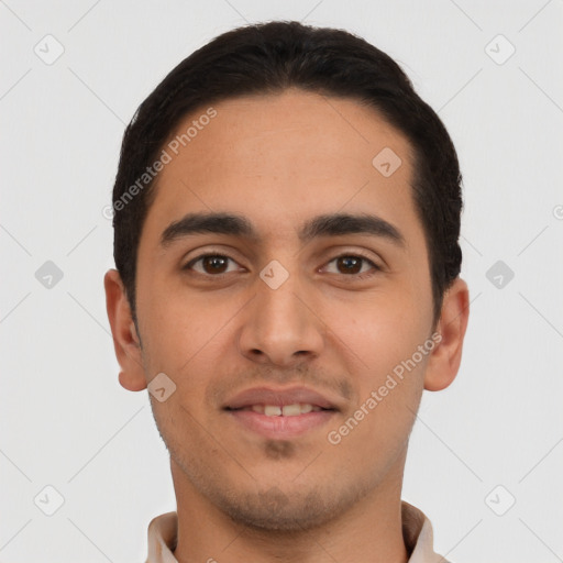 Joyful latino young-adult male with short  black hair and brown eyes