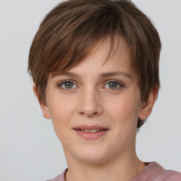 Joyful white young-adult female with short  brown hair and grey eyes