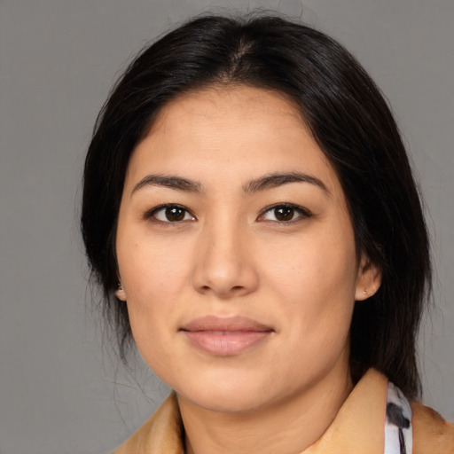 Joyful latino young-adult female with medium  black hair and brown eyes