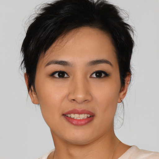 Joyful asian young-adult female with short  black hair and brown eyes