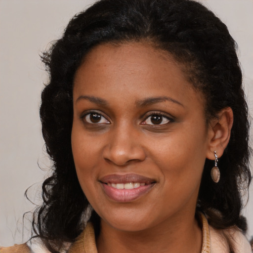Joyful black young-adult female with medium  brown hair and brown eyes