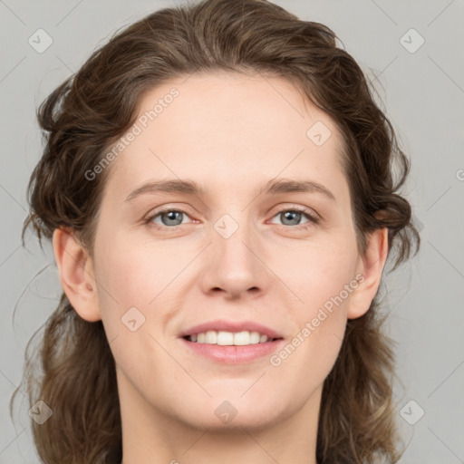 Joyful white young-adult female with medium  brown hair and grey eyes