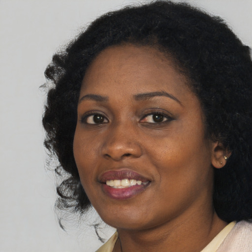 Joyful black young-adult female with medium  black hair and brown eyes