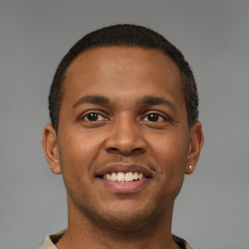 Joyful latino young-adult male with short  brown hair and brown eyes