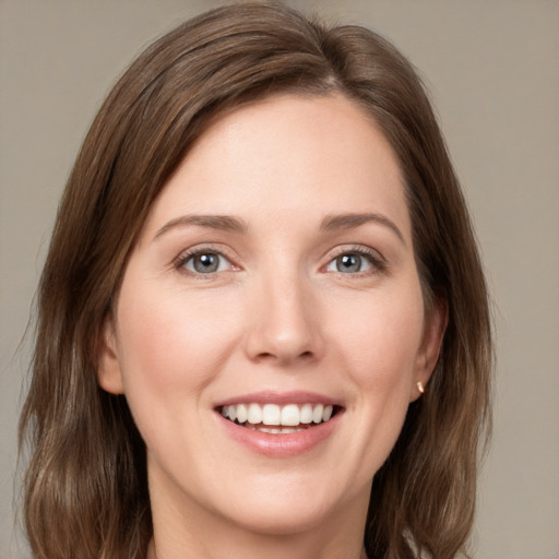 Joyful white young-adult female with medium  brown hair and green eyes