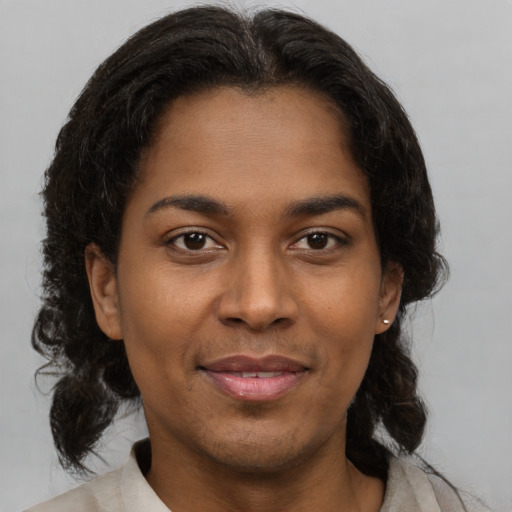 Joyful black young-adult female with medium  brown hair and brown eyes