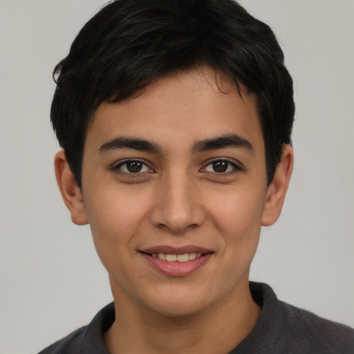 Joyful latino young-adult male with short  brown hair and brown eyes