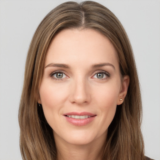 Joyful white young-adult female with long  brown hair and green eyes