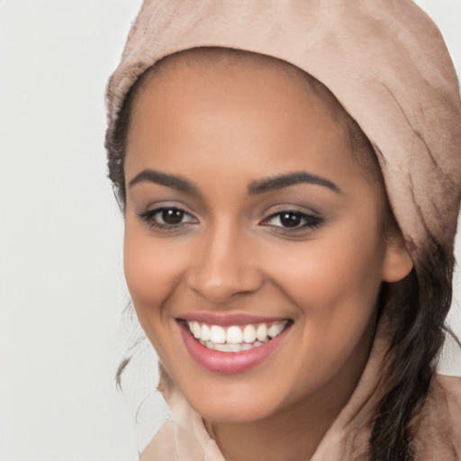 Joyful latino young-adult female with long  brown hair and brown eyes