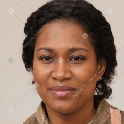 Joyful black adult female with long  brown hair and brown eyes