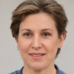 Joyful white adult female with short  brown hair and grey eyes